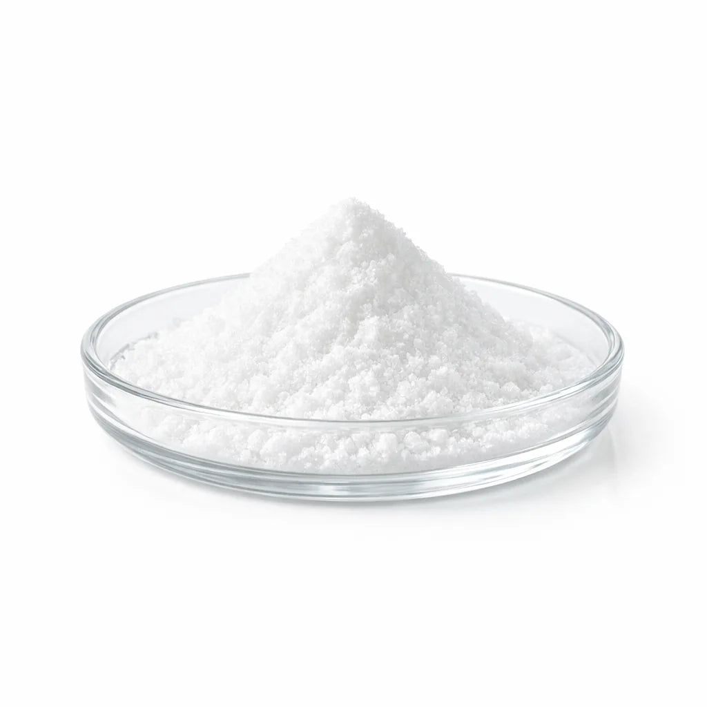 Fine white crystalline powder in a glass dish