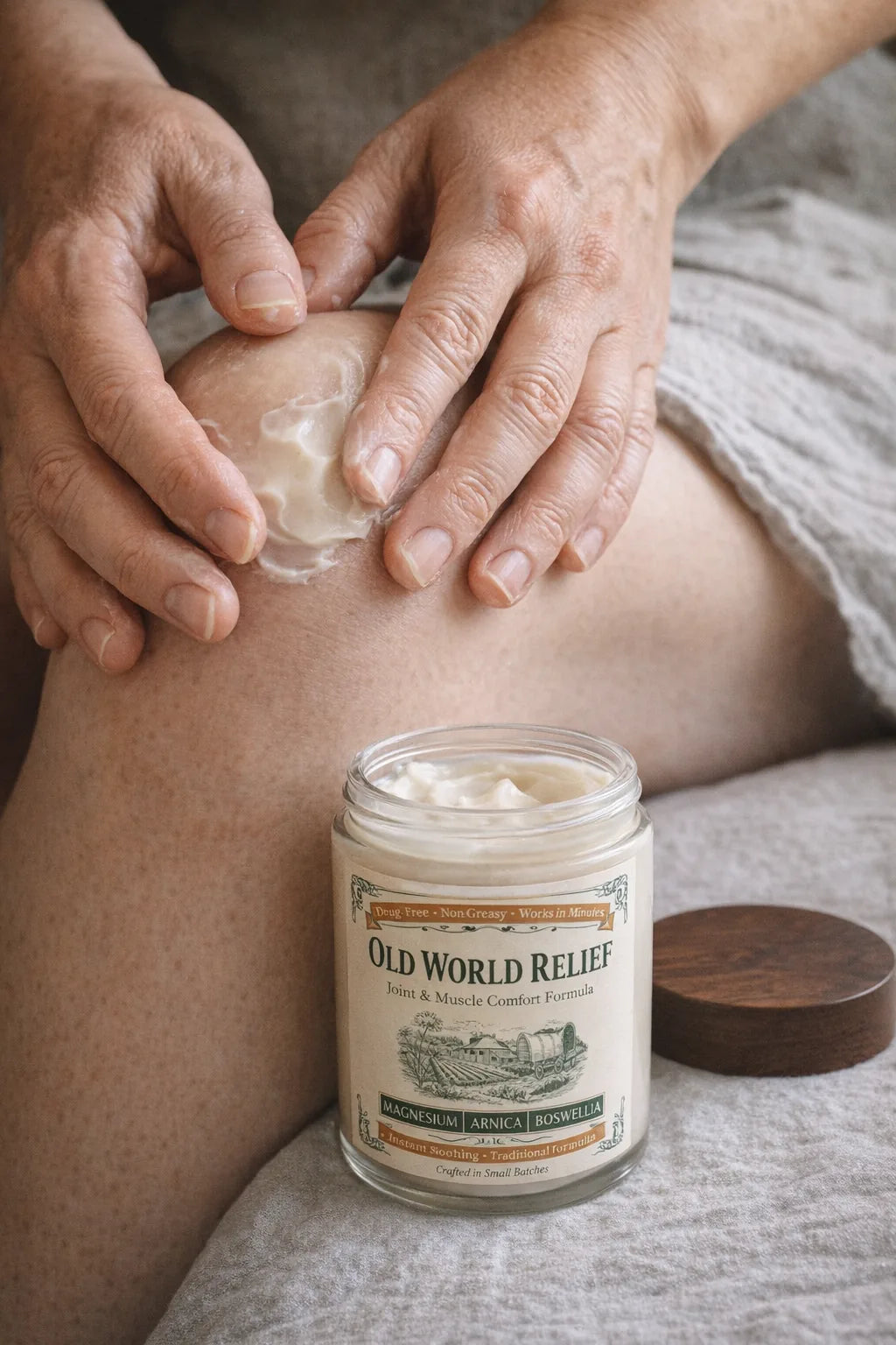 Hands working a coin-sized dollop of the cream into a knee