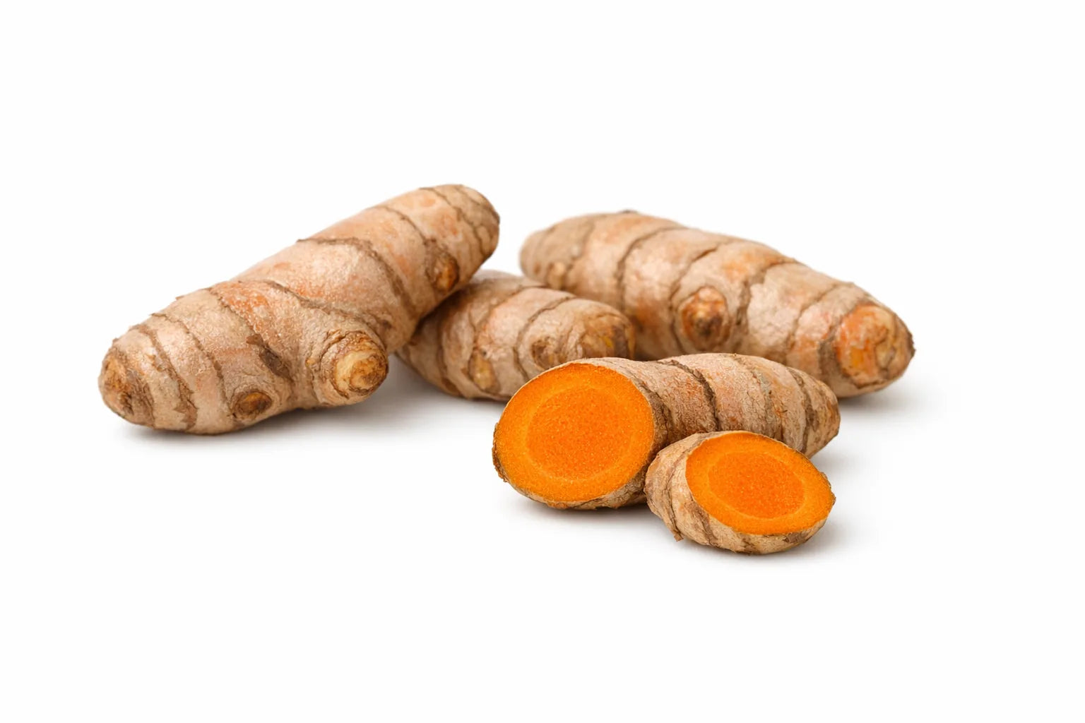 Fresh turmeric rhizomes, one cut open